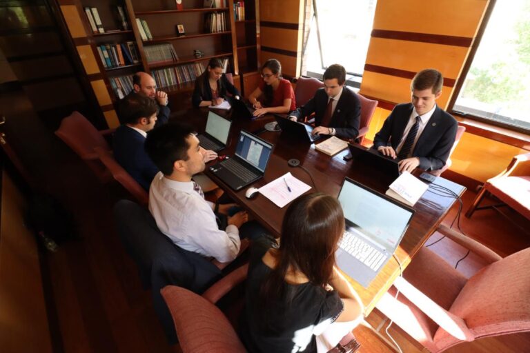 Abogados de Comunidad y Justicia trabajando en torno a una mesa de reuniones